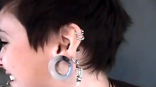 Heavily pierced and tattooed brunette..