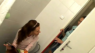 Naughty girl licks another in a toilet